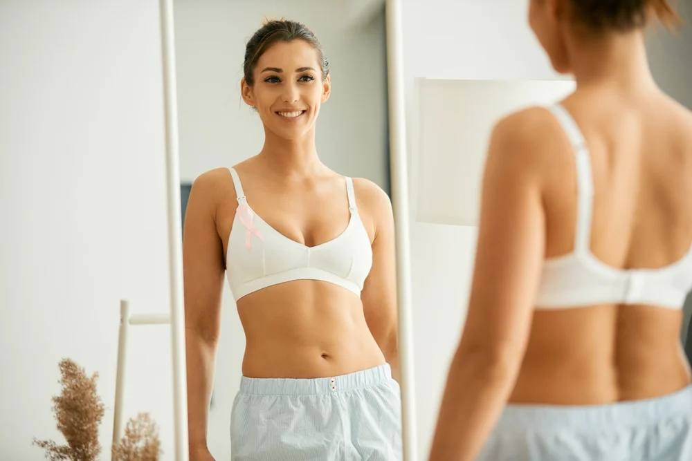 A woman looking in mirror after skin treatment